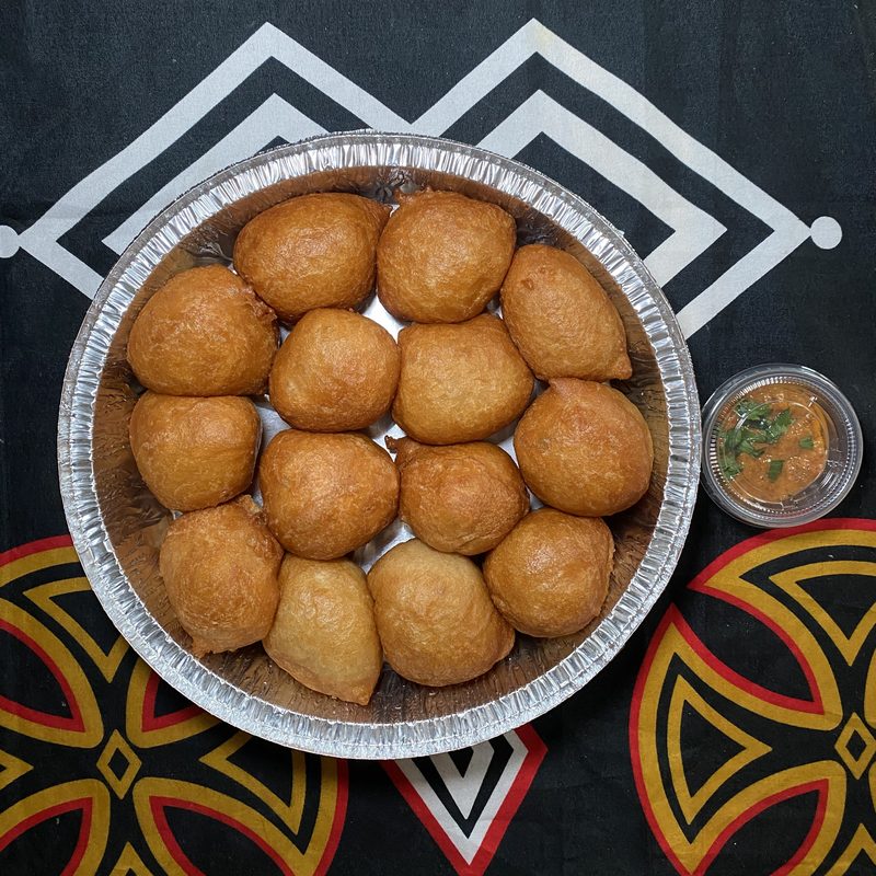 Plain beignets served with herb dipping sauce and red pepper sauce